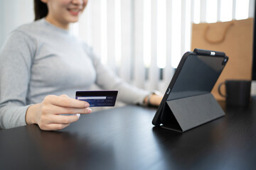 Close up hand using mobile phone and credit card for online payment, electronic wallet.