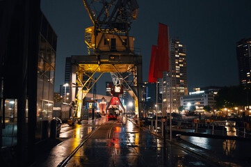 Rotterdam port cranes with lights by night