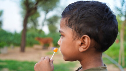 An handsome Indian kid looking very funny. .