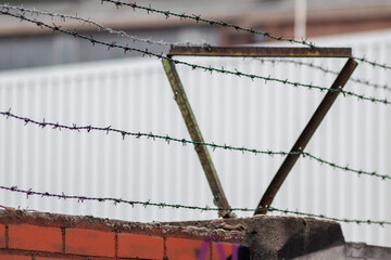 Barbed wire fence as protection and no trespassing safety symbol and warning for defense and...
