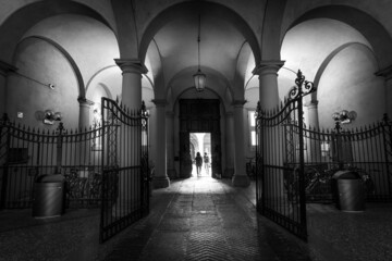 The arches of the old city. Walking through the old town of Prague. Czech Republic. Black and white