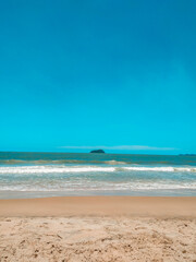 Fototapeta na wymiar beach with blue sky, sand and island