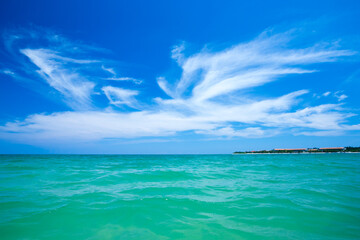 Fototapeta na wymiar clouds on blue sky over calm sea with sunlight reflection