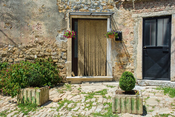 Fototapeta na wymiar Doors in old stone residential buildings in the historic medieval village of Buje in Istria, Croatia 