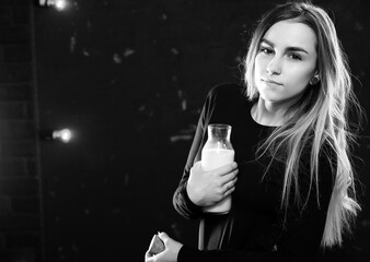 Young girl drinks milk from a bottle