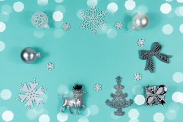 White and silver Christmas decorations on a blue background, top view, flat lay. Christmas mood....