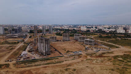 Construction site for a new city block. Construction work is underway. The constructed buildings are visible. Aerial photography.