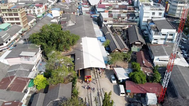 MAEKLONG, THAILAND - DECEMBER 15, 2019: Amazing aerial view of Maeklong cityscape with river and railway market