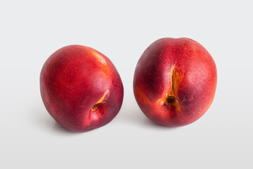 Two ripe, juicy nectarines with a delicate velvety skin