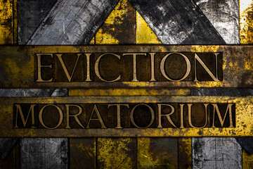 Eviction Moratorium text message on textured grunge copper and vintage gold background - obrazy, fototapety, plakaty