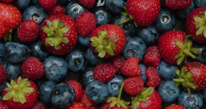 Summer berries, strawberries, raspberries and blueberries. Various colorful berries rotation.
