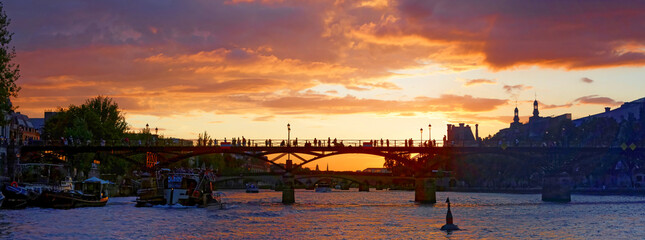 Sunset over the Arts bridge in Paris, France. Built between 1801 and 1804, it was the first iron...