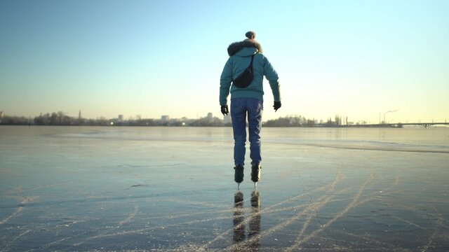 Adult caucasian woman in blue jacket and light jeans skates - Powered by Adobe