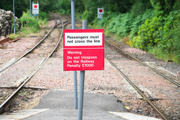 Fototapeta na wymiar Passengers must not cross the line sign at railway train station