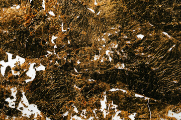 Gold foil background on paper with torn edges