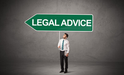 Young business person in casual holding road sign