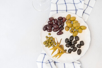 Italian antipasti, different types of olives, capers, peppers Mediterranean assortment of delicious food, wine snacks
