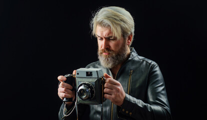 Fototapeta premium Bearded man with Vintage photo camera. Stylish photographer in leather jacket with Retro camera.