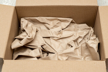 Open cardboard box full of wrapping paper close up
