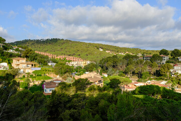 Fototapeta na wymiar Green summer mountain landscape with many small summer houses in Begur, Catalonia