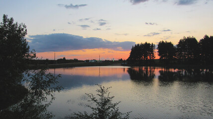 Pine forest and lake at sunset