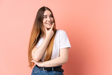 Young caucasian woman isolated on pink background smiling