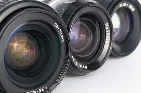 Fototapeta Modern and old DSLR camera lens set on white background close-up