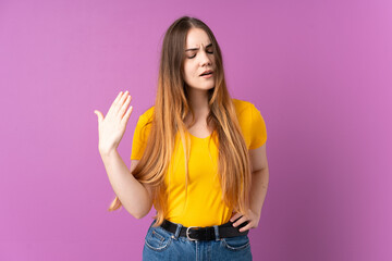 Young caucasian woman isolated on purple background with tired and sick expression