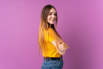 Young caucasian woman isolated on purple background with arms crossed and looking forward