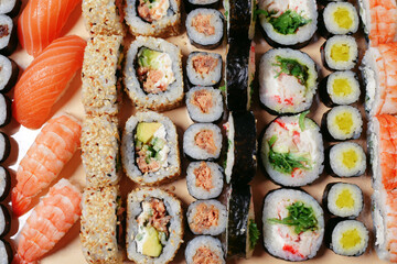 Maki and nigiri, sushi with fish, fresh salmon, shrimp and cheese, avocado rolls. Futomaki and Philadelphia with California. Set sushi