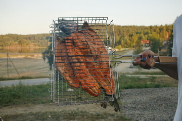Grill with freshly cooked fish. cooking fish trout on the grill