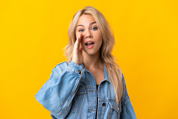 Young Russian woman isolated on yellow background shouting with mouth wide open