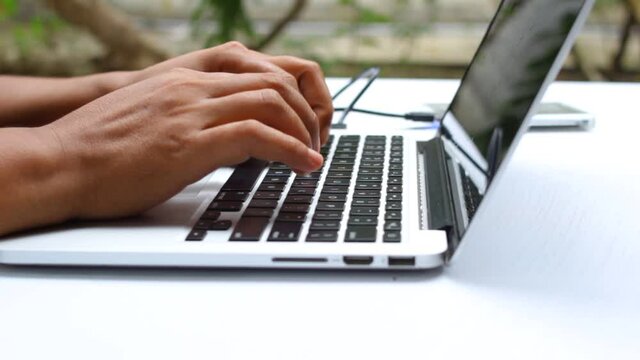 working outside with laptop while smoking, and external hard drive plugged in