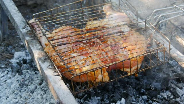 Whole juicy with spices grilled chicken tabaka or tapaka at summer picnic