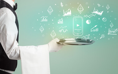 Handsome young waiter in tuxedo holding money icons on tray