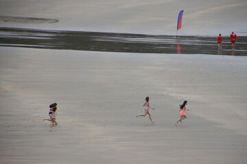 Girls running on the beach