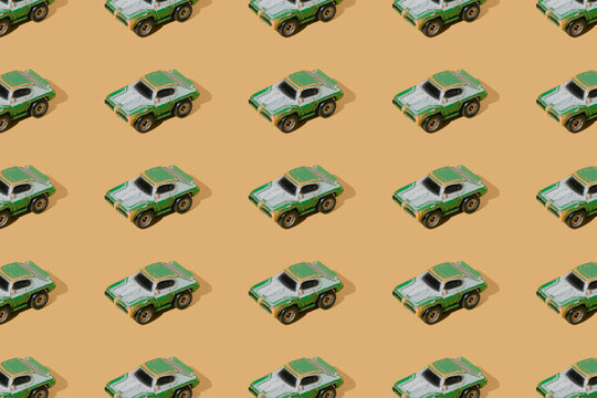 Old Metal Sport Car Toy Green Color On Yellow Gold Luxury Background. Minimal Design. Pattern.