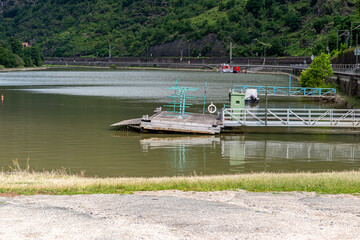 Obraz premium A metal platform protruding from the river bank on air tanks, a pier to the entrance to the ship.