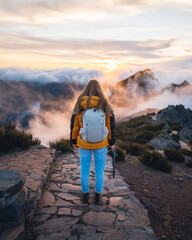 A young adventurous woman traveling and hiking alone in the mountains of Madeira in Portugal. High...