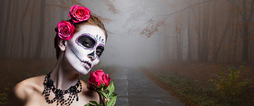 Closeup portrait of a young woman with sugar skull makeup, showing Calavera Catrina. Dia de los muertos. Day of The Dead. Halloween