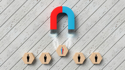 magnet attracting a hexagon with a person symbol on it on white wood background