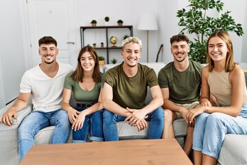 Group of young friends smiling happy sitting on the sofa at home.