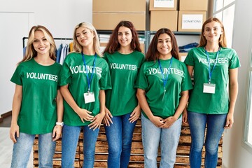 Group of young volunteers woman smiling happy at charity center.