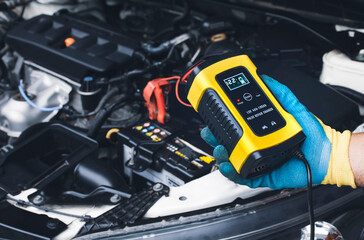 Technician recharge car battery with automatic battery charger