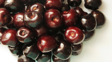 close up of cherries on white background