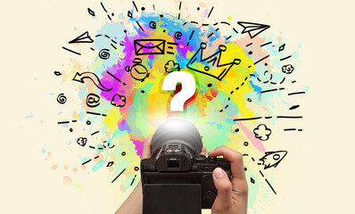 Close-up of a hand holding digital camera with abstract drawing