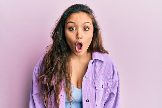 Young hispanic girl wearing casual clothes afraid and shocked with surprise expression, fear and excited face.