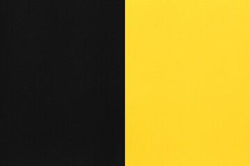 Black and yellow paper stacked on top of art background.