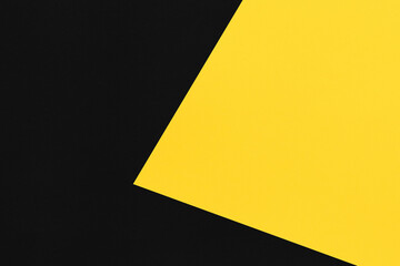 Black and yellow paper stacked on top of art background.