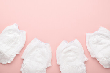 Diapers are disposable panties on a pink background with a place to copy.